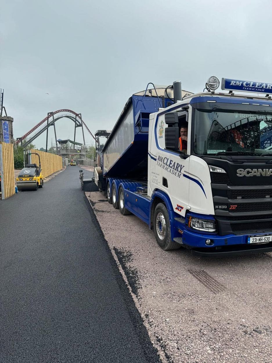 An RM Cleary tipper truck alongside a freshly surfaced road.