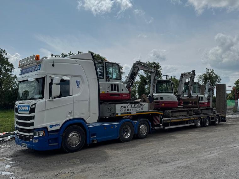 The RM Cleary Scania R650 low-loader with three tracked excavators loaded.