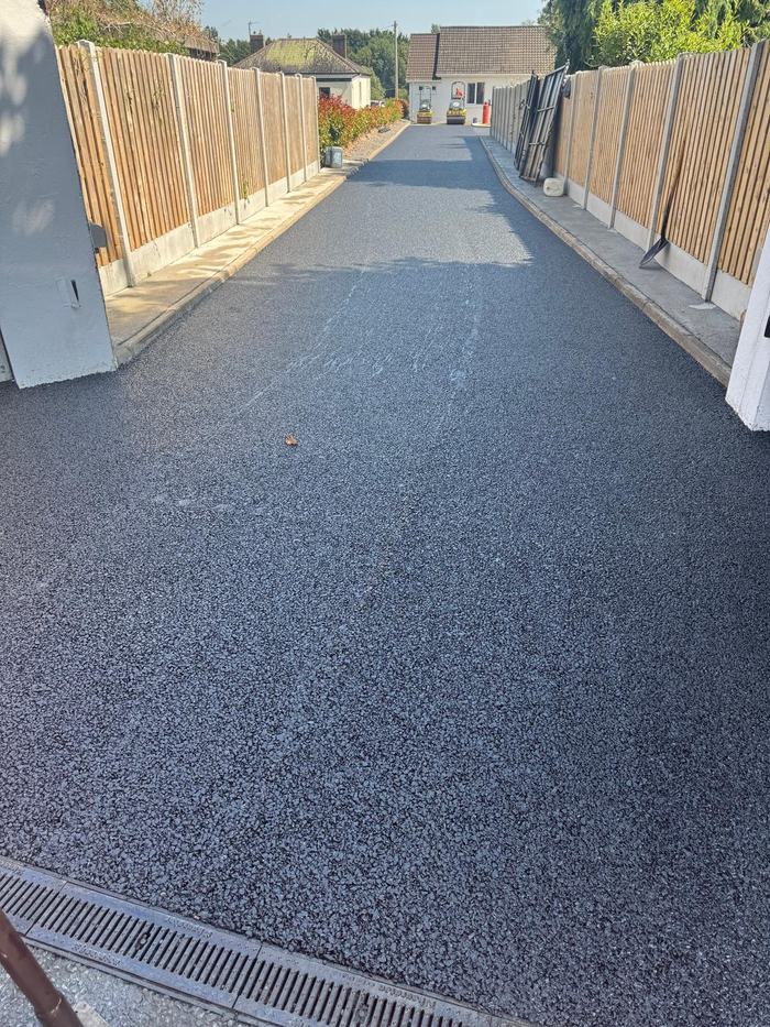 The finished drive running between the boundary fences from the entrance up to the house.