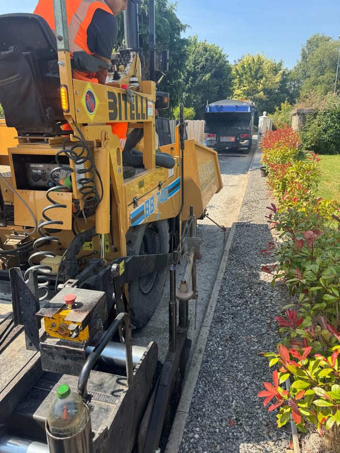 The RM Cleary Bitelli paver laying up to the kerb line with a tipper waiting ahead to keep it fed.