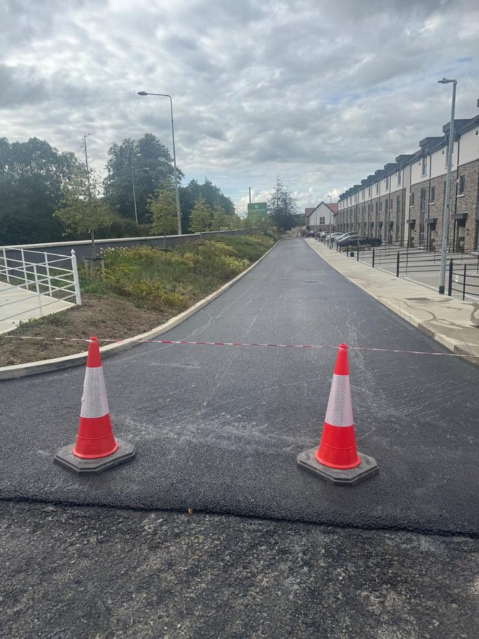 The newly laid surface closed off to traffic while it cools.