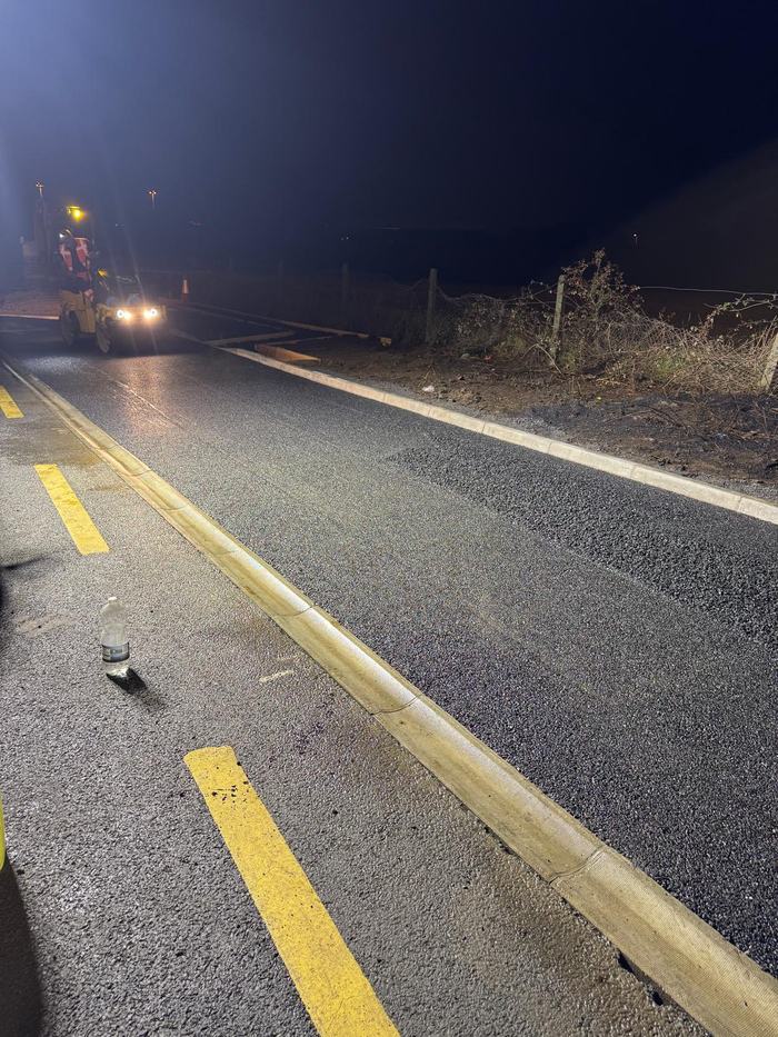 The completed surface alongside the running lane, kerbed and lined, ready to be opened back up.