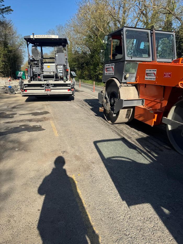 The paver and roller standing on site between runs.