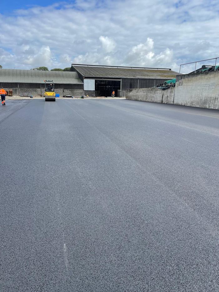 The completed surface running up to the sheds, with the roller finishing the far side.